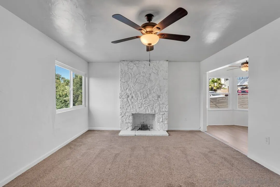 7901 Hillside Drive La Mesa, CA 91942 - Photo 23 of 52 an empty room with fireplace and fan