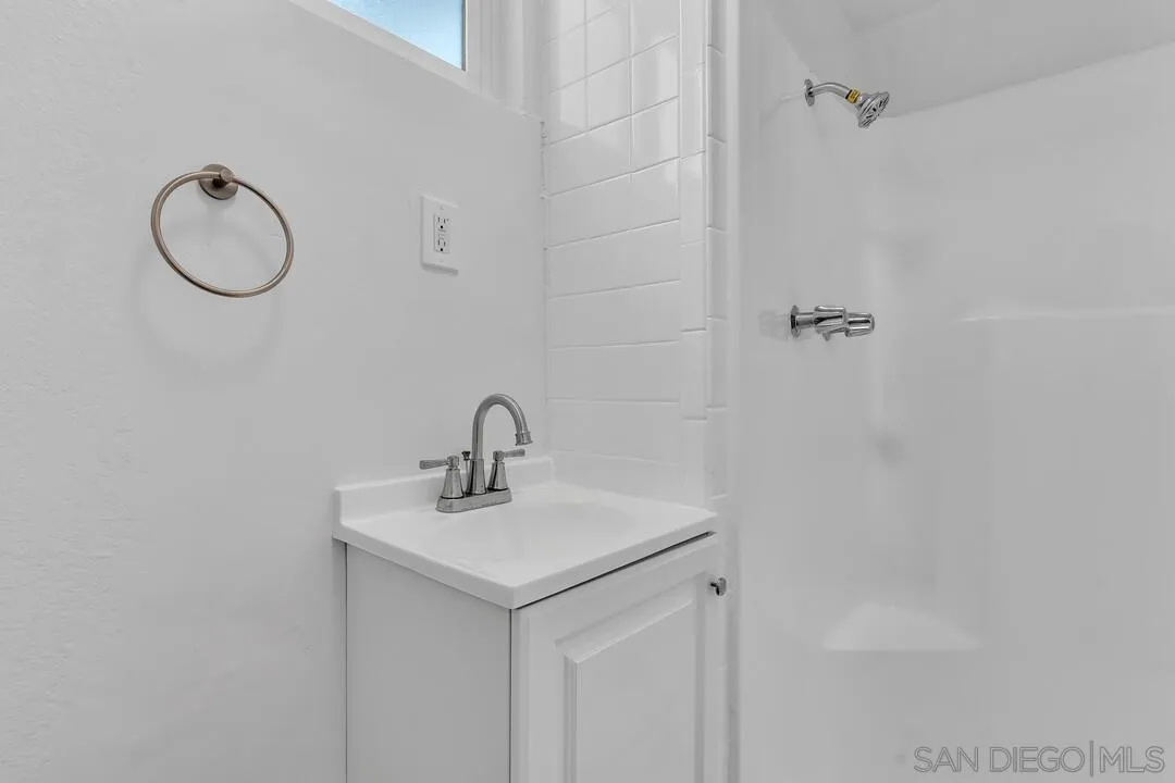 7901 Hillside Drive La Mesa, CA 91942 - Photo 40 of 52 a bathroom with a sink a mirror and a shower