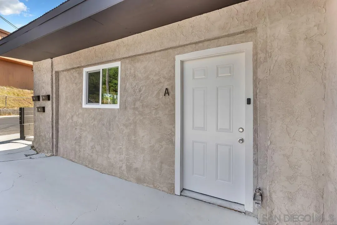 7901 Hillside Drive La Mesa, CA 91942 - Photo 6 of 52 a view of a hallway with wooden shelves