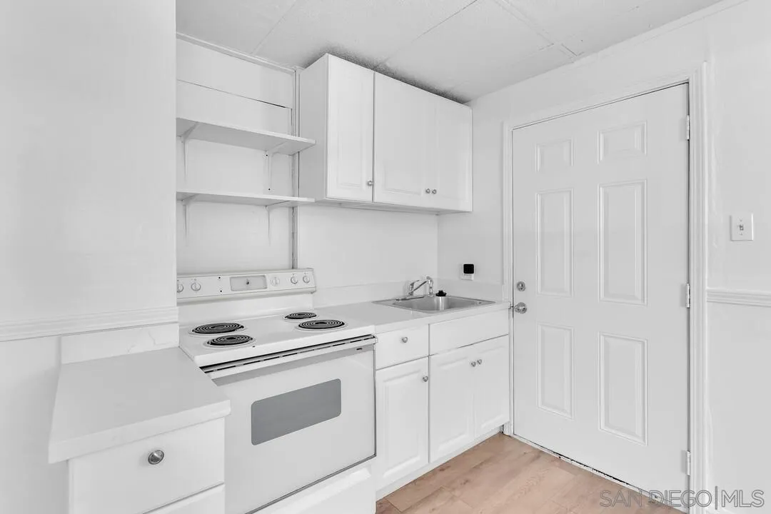 7901 Hillside Drive La Mesa, CA 91942 - Photo 8 of 52 a kitchen with white cabinets and white appliances