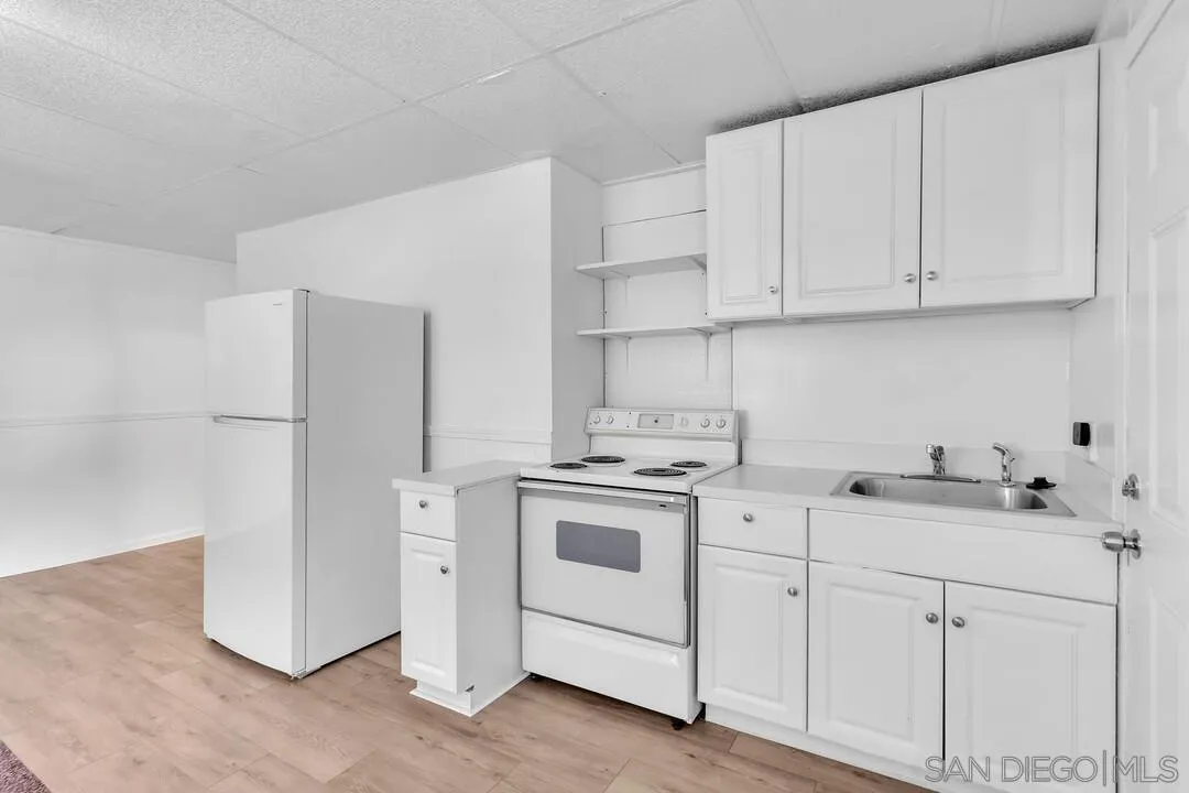 7901 Hillside Drive La Mesa, CA 91942 - Photo 9 of 52 a kitchen with white cabinets and white appliances