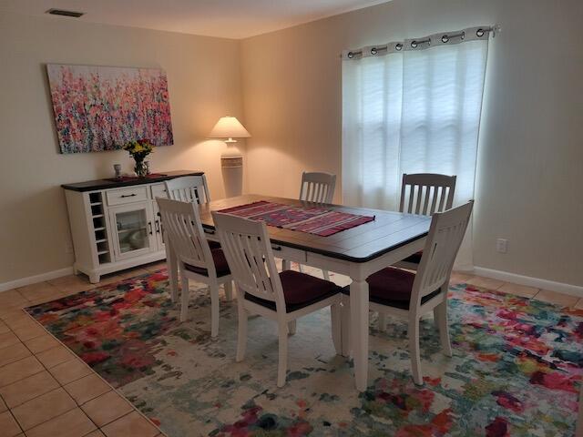 1008 Ocean Dunes Circle Jupiter, FL 33477 - Photo 3 of 19 a dining room with furniture and wooden floor