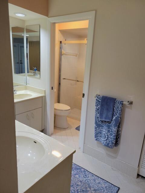 1008 Ocean Dunes Circle Jupiter, FL 33477 - Photo 6 of 19 a bathroom with a toilet a sink and mirror