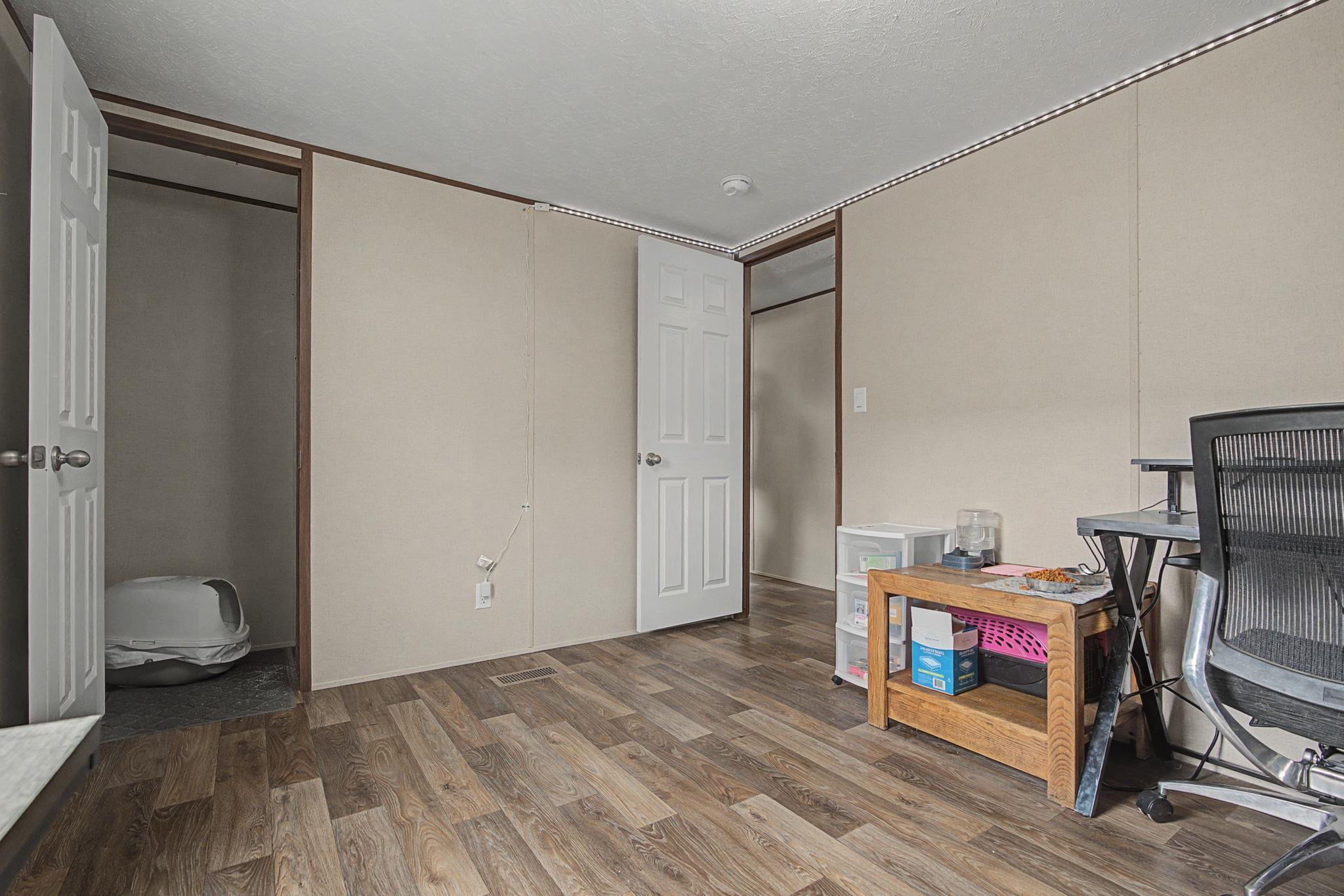 269 Clements Way Fruita, CO 81521 - Photo 14 of 20 a view of room with wooden floor and bathroom