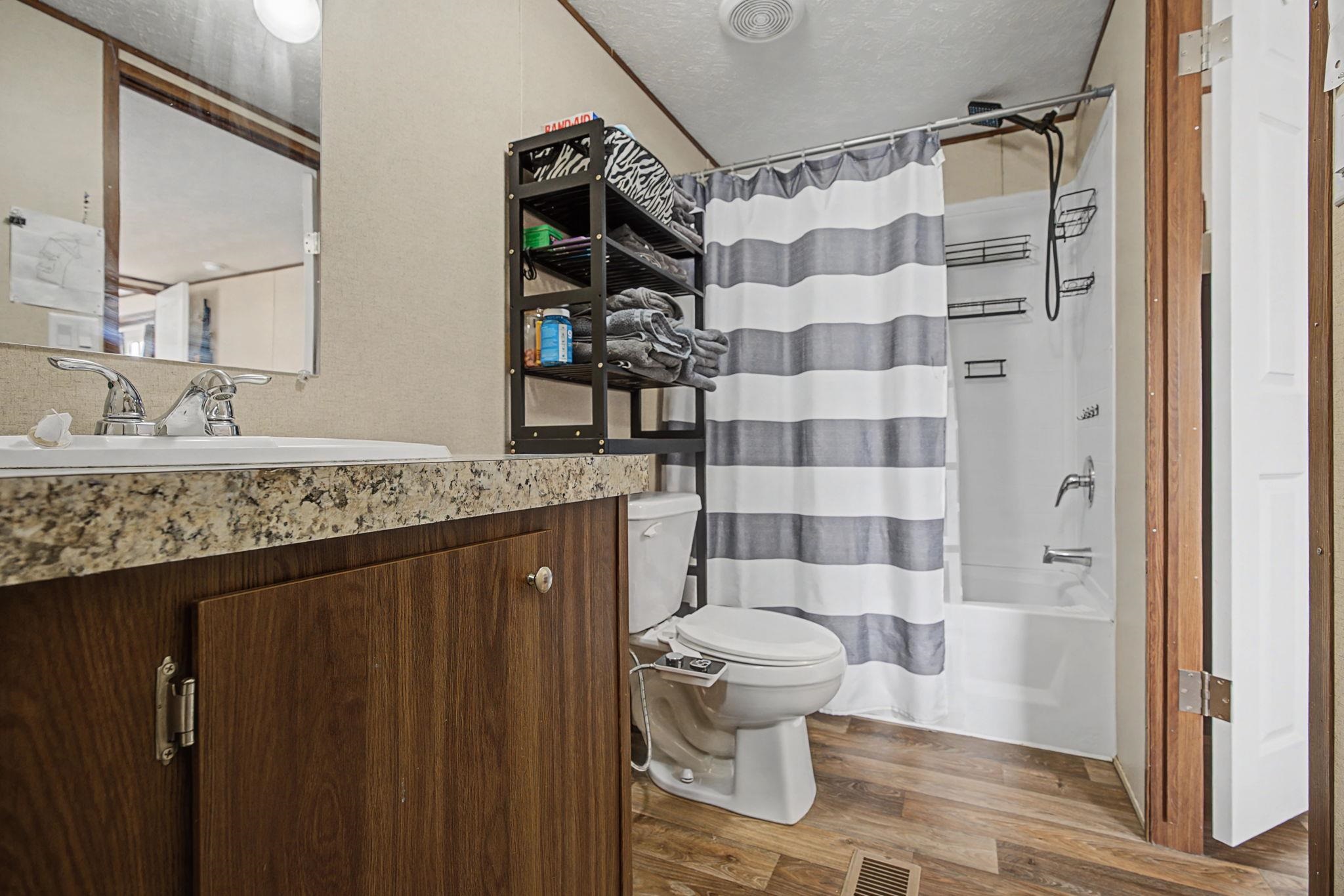 269 Clements Way Fruita, CO 81521 - Photo 15 of 20 a bathroom with a granite countertop sink toilet and shower
