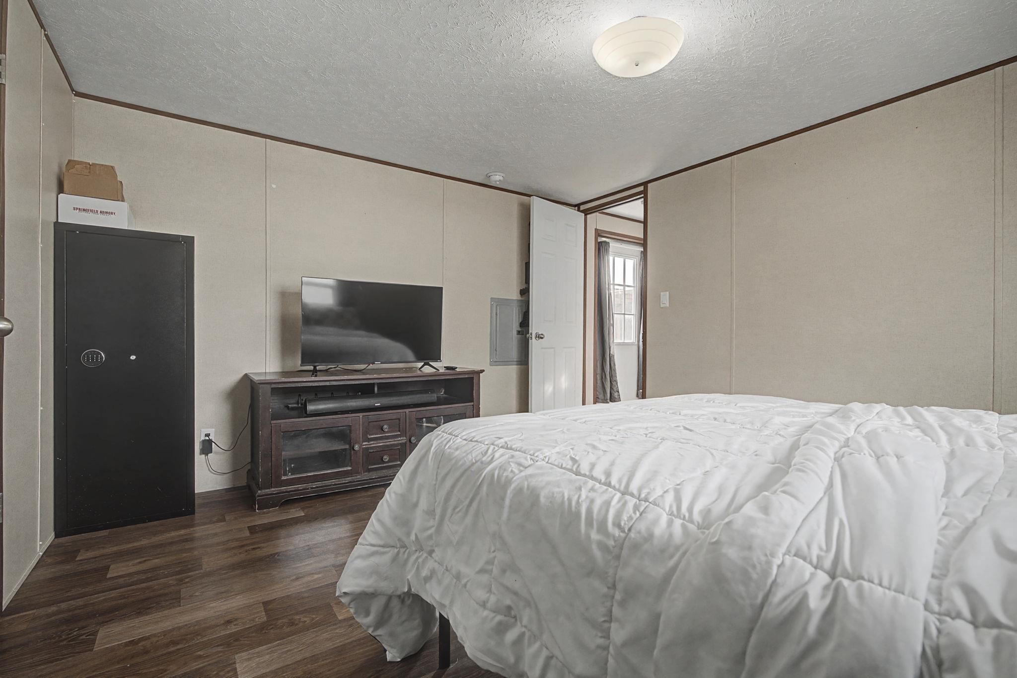 269 Clements Way Fruita, CO 81521 - Photo 17 of 20 a bedroom with a bed and a flat screen tv