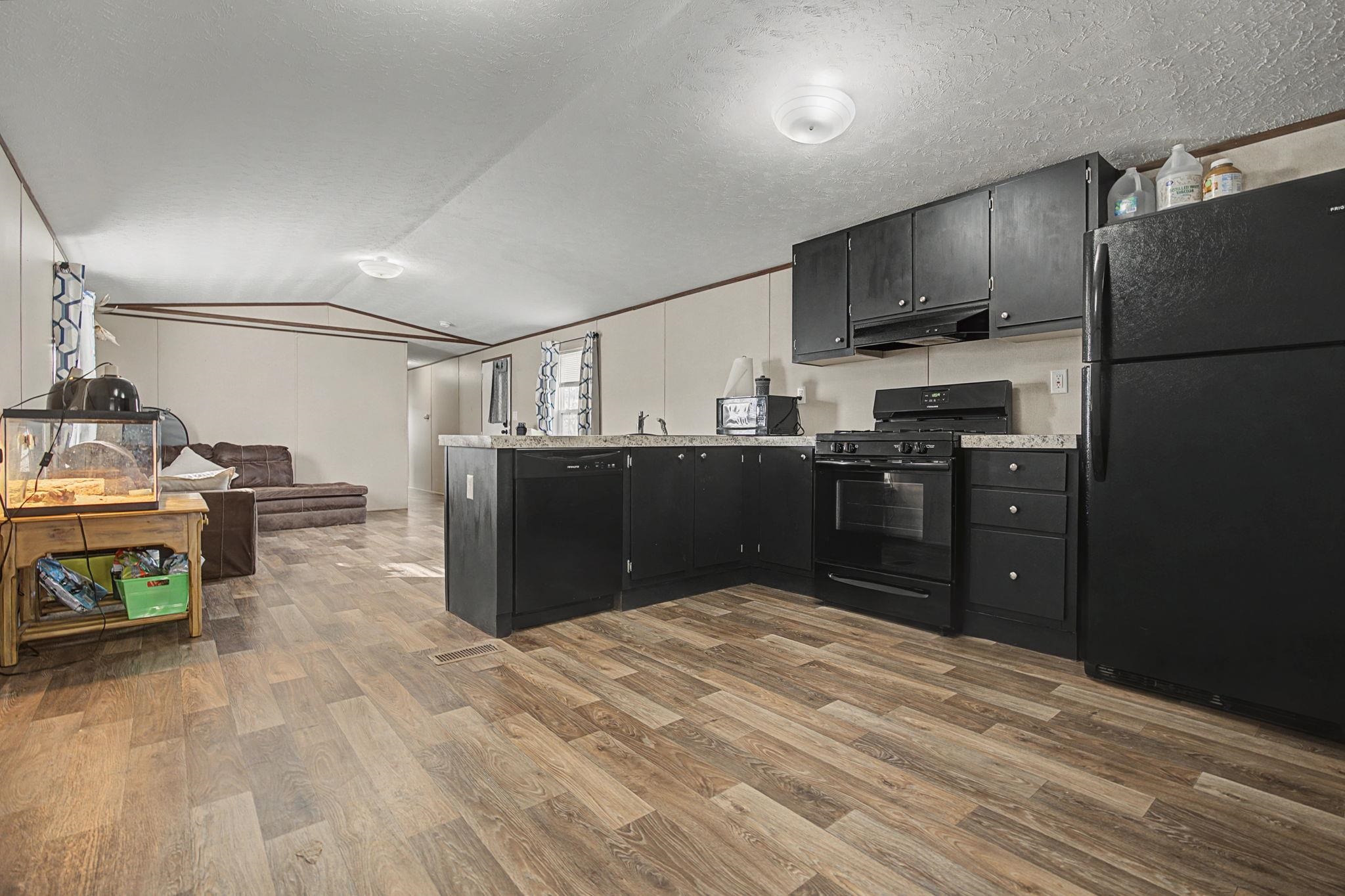 269 Clements Way Fruita, CO 81521 - Photo 6 of 20 a kitchen with stainless steel appliances granite countertop a refrigerator a stove a sink and a microwave