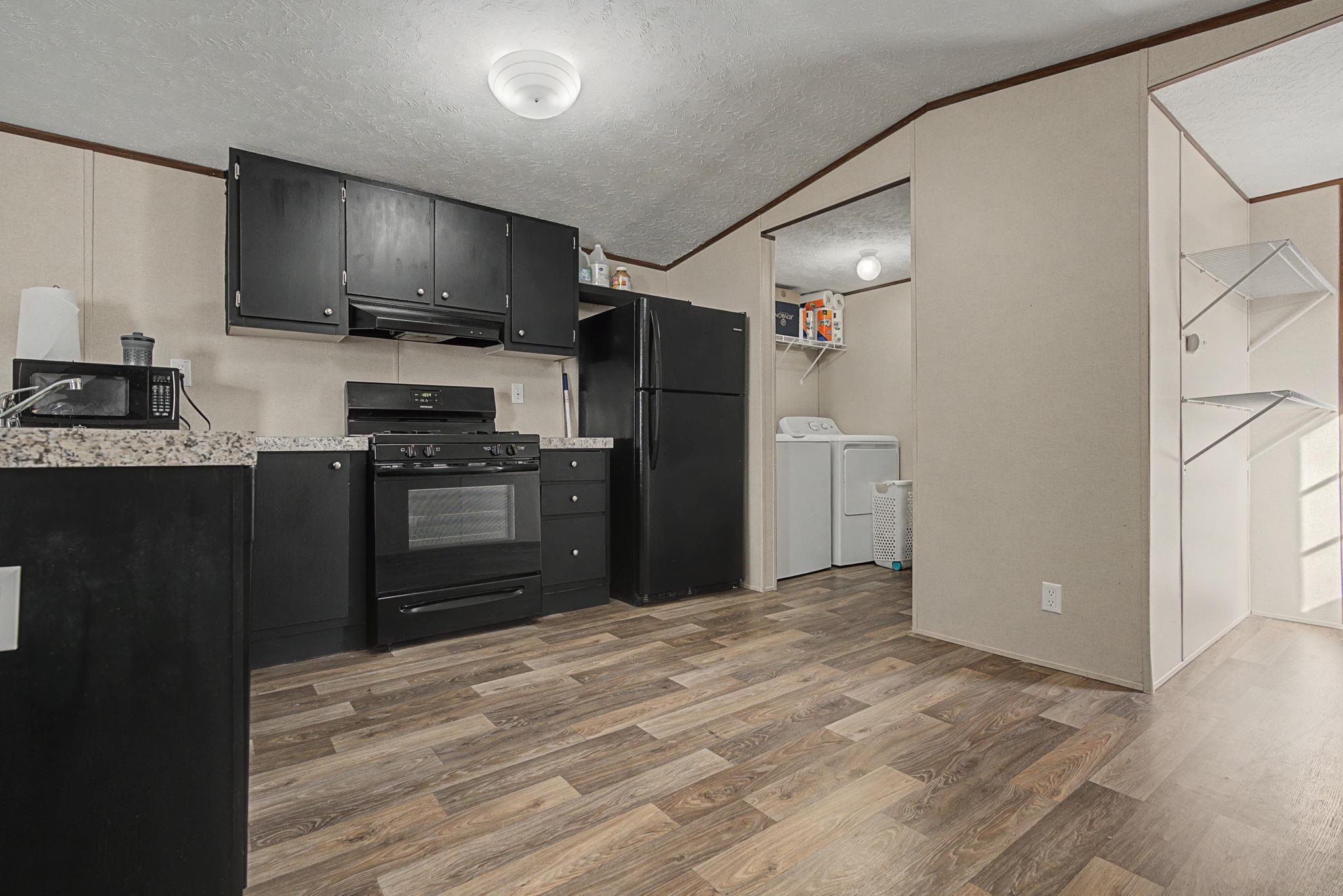 269 Clements Way Fruita, CO 81521 - Photo 7 of 20 a kitchen with a refrigerator and a stove top oven