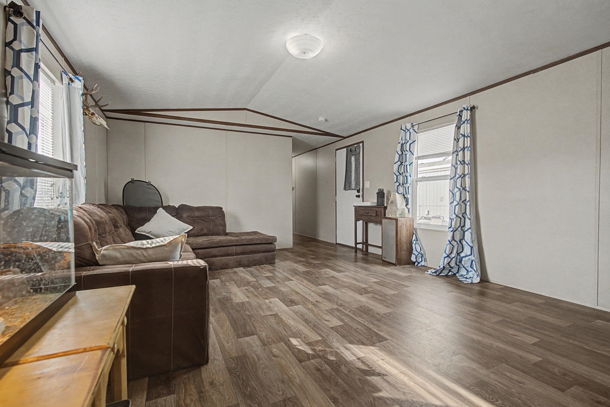 269 Clements Way Fruita, CO 81521 - Photo 9 of 20 a room with furniture and wooden floor