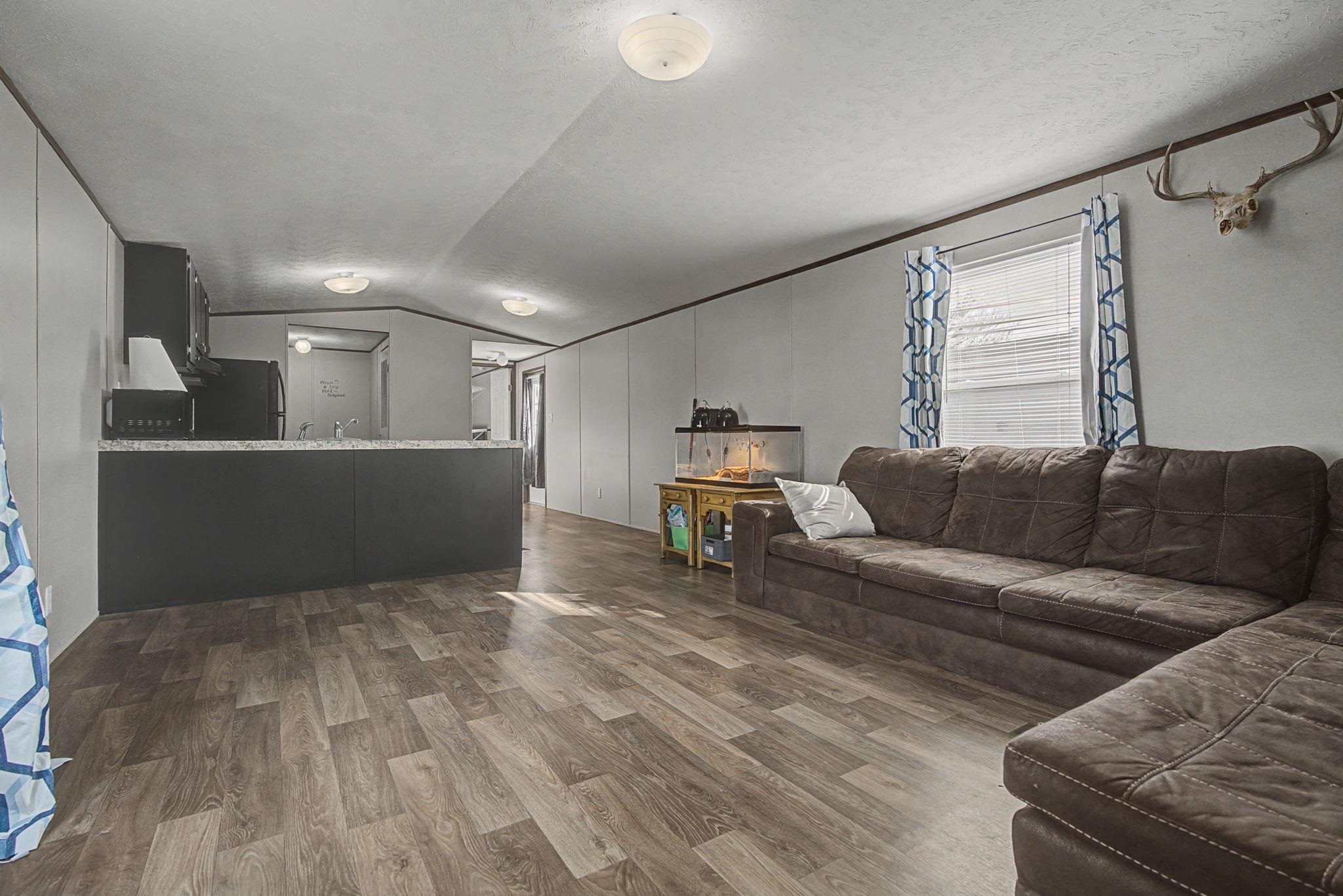 269 Clements Way Fruita, CO 81521 - Photo 10 of 20 a living room with furniture and a wooden floor