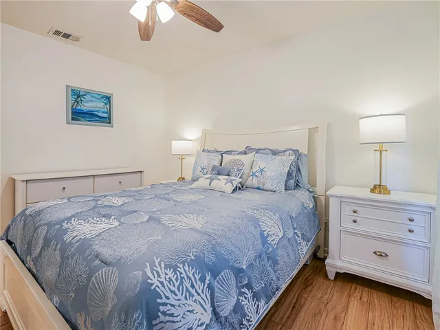 a bedroom with a bed and a ceiling fan