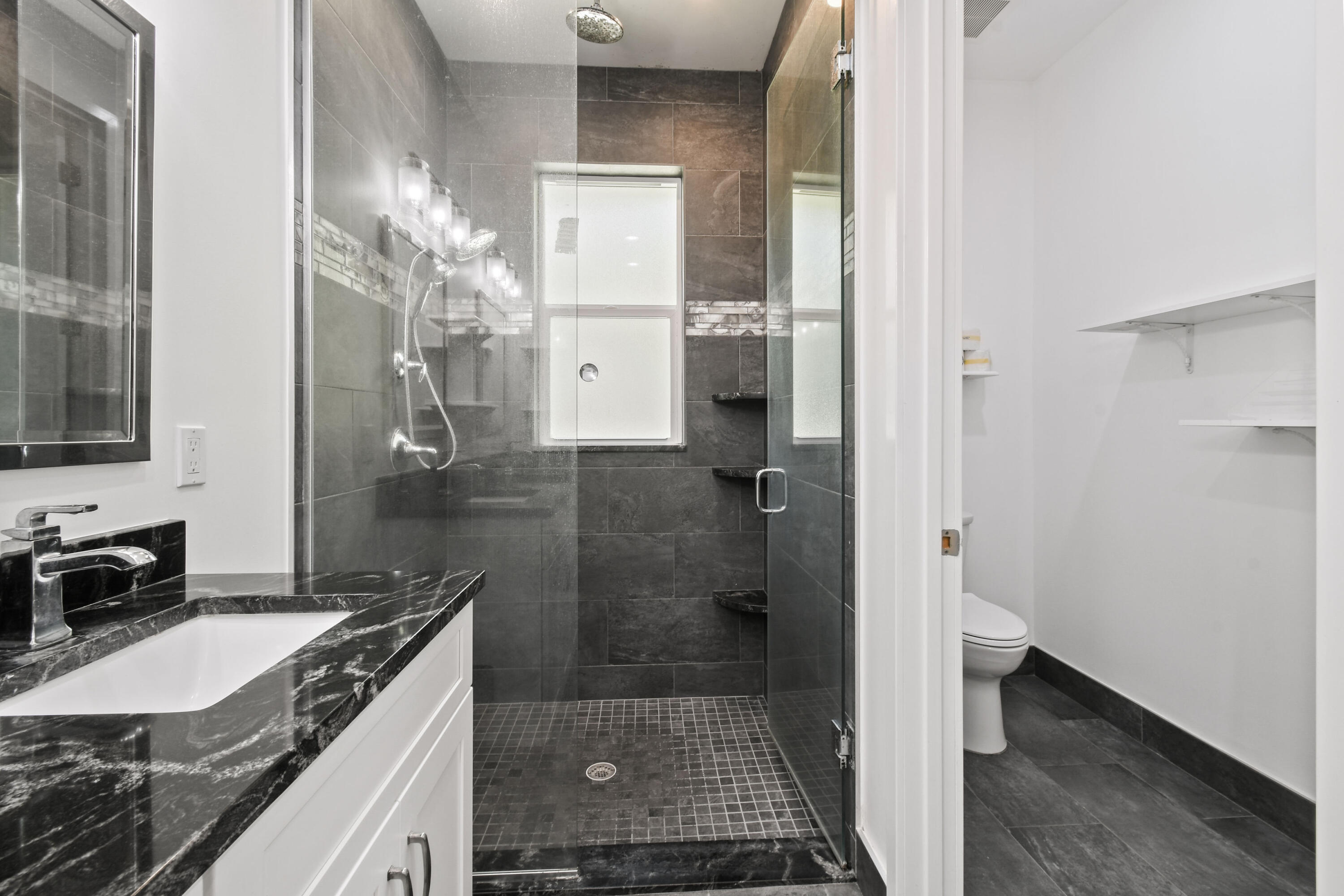 5782 Russakis Road Fort Pierce, FL 34951 - Photo 28 of 90 a bathroom with a granite countertop shower a sink and a mirror