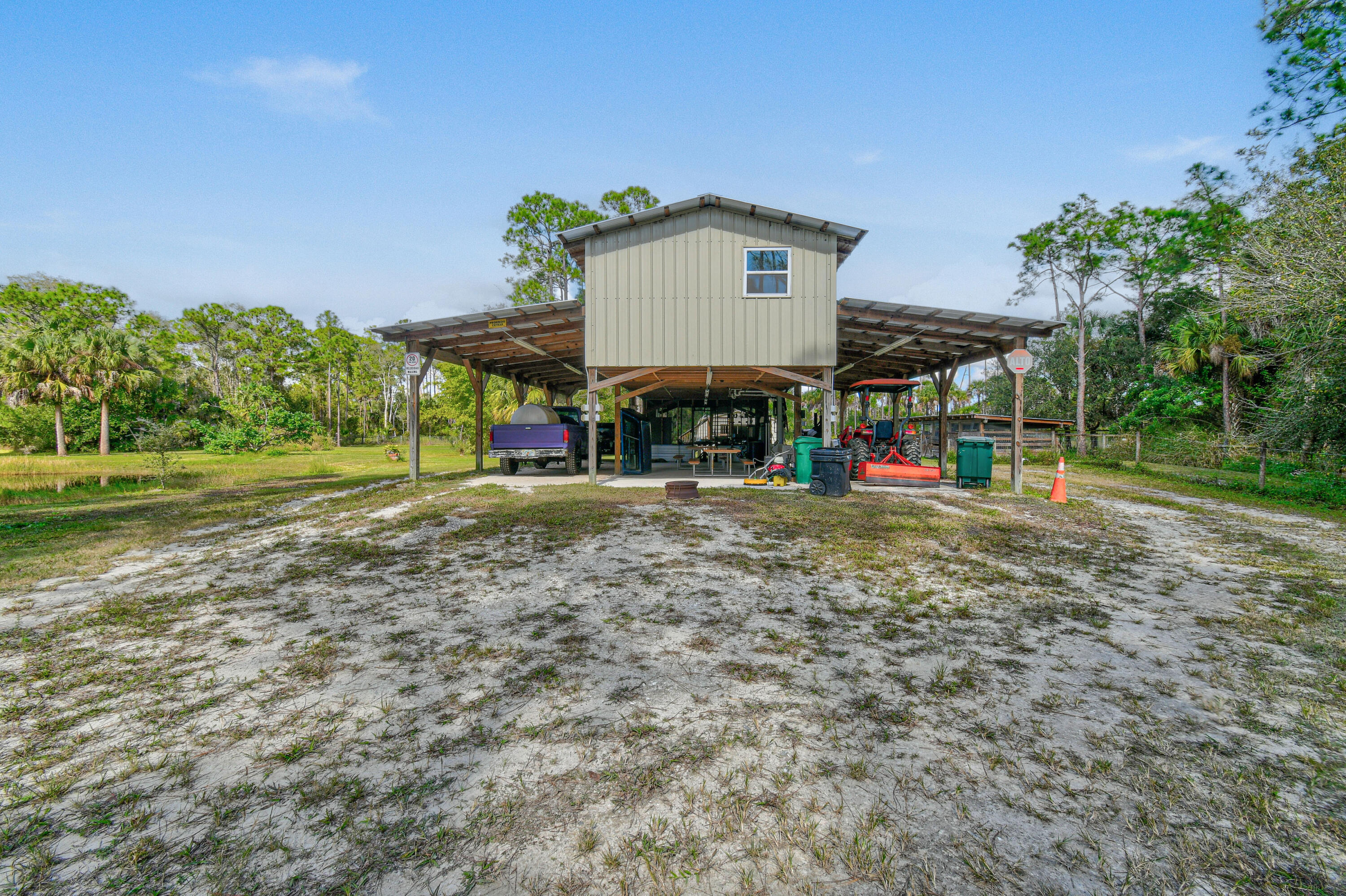 5782 Russakis Road Fort Pierce, FL 34951 - Photo 40 of 90 a view of a house with a yard and potted plants