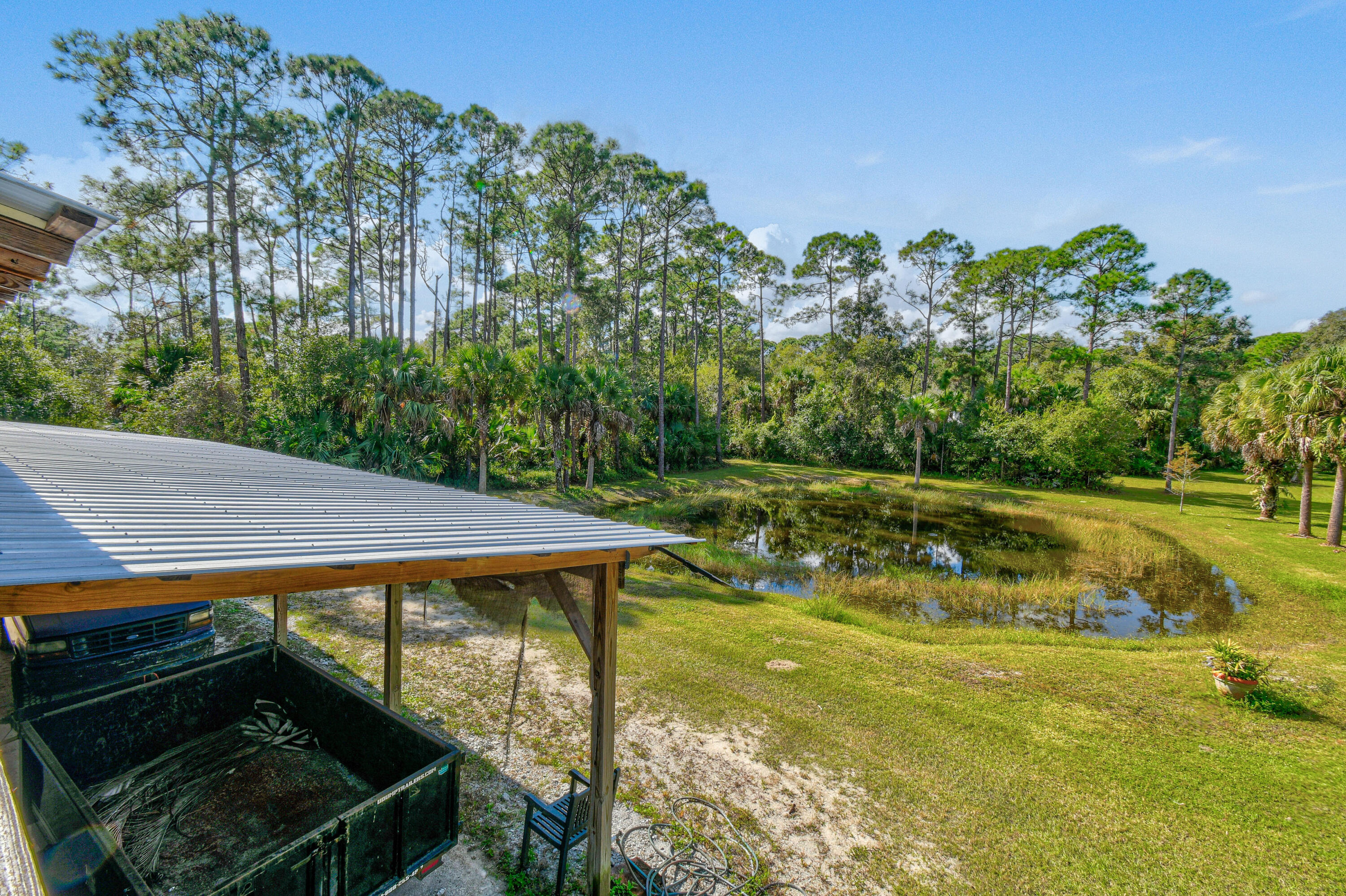 5782 Russakis Road Fort Pierce, FL 34951 - Photo 58 of 90 a view of backyard with swimming pool and outdoor seating