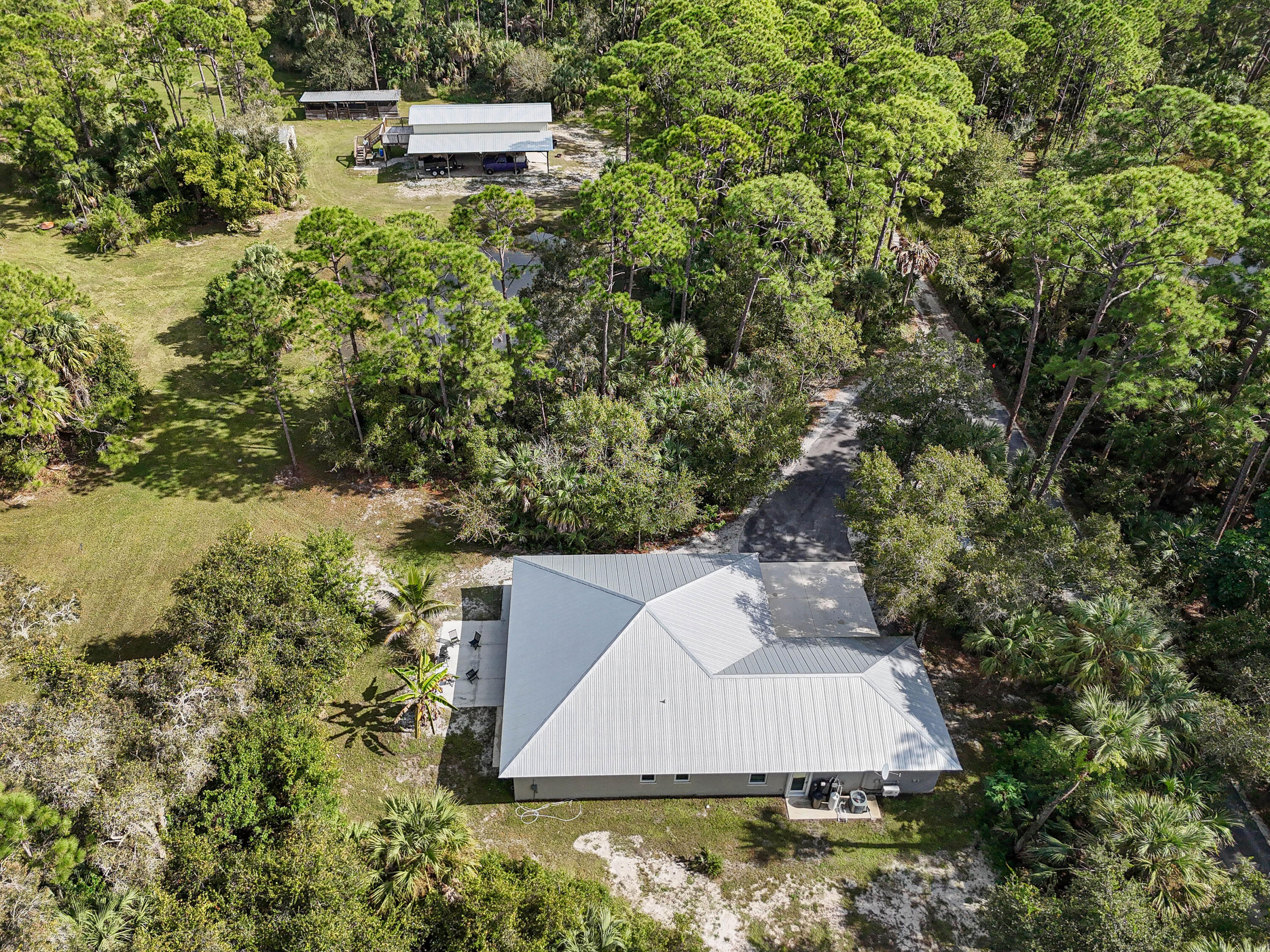5782 Russakis Road Fort Pierce, FL 34951 - Photo 66 of 90 an aerial view of a house with a yard and lake view