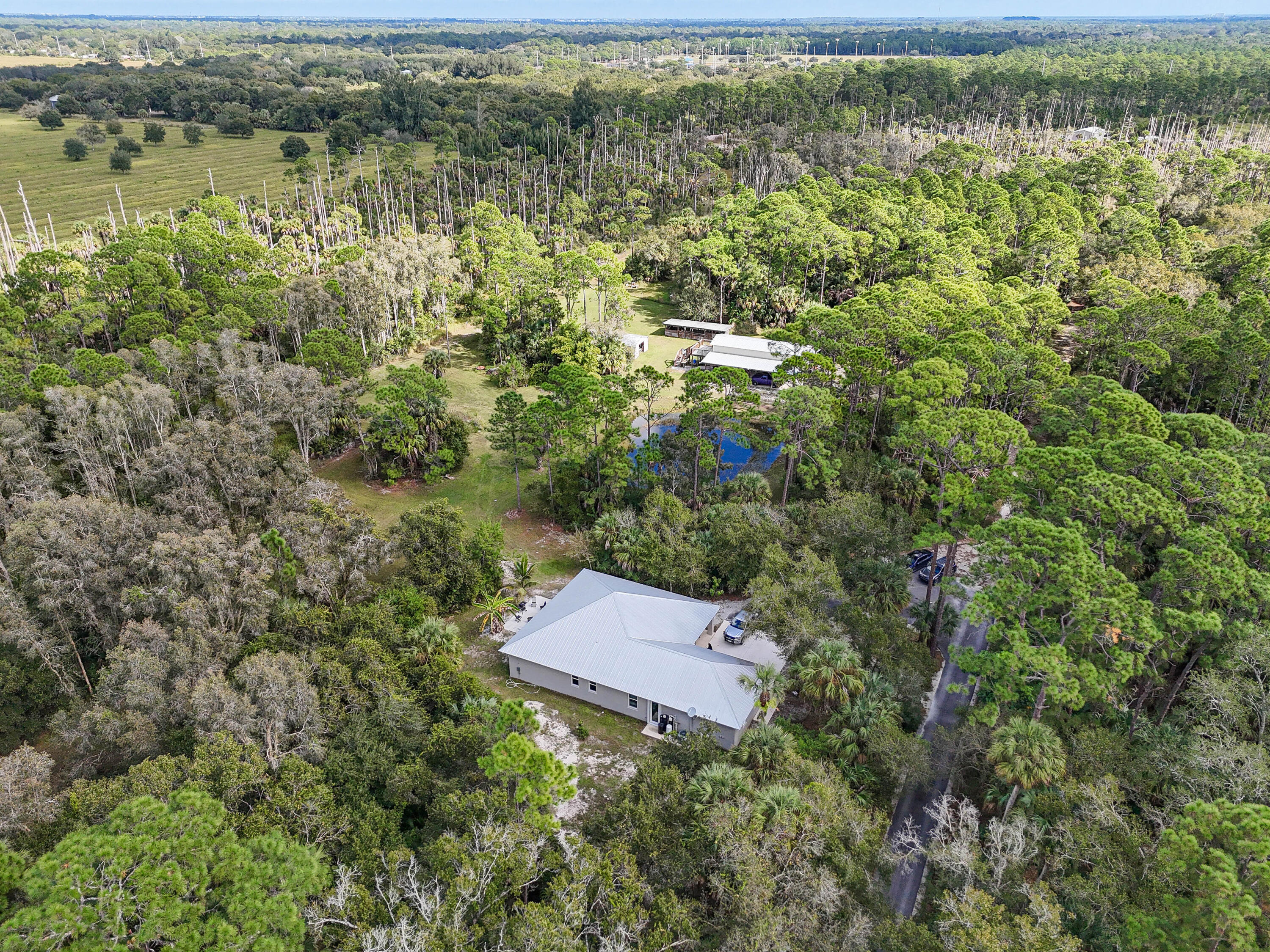 5782 Russakis Road Fort Pierce, FL 34951 - Photo 67 of 90 an aerial view of residential house with outdoor space and lake view