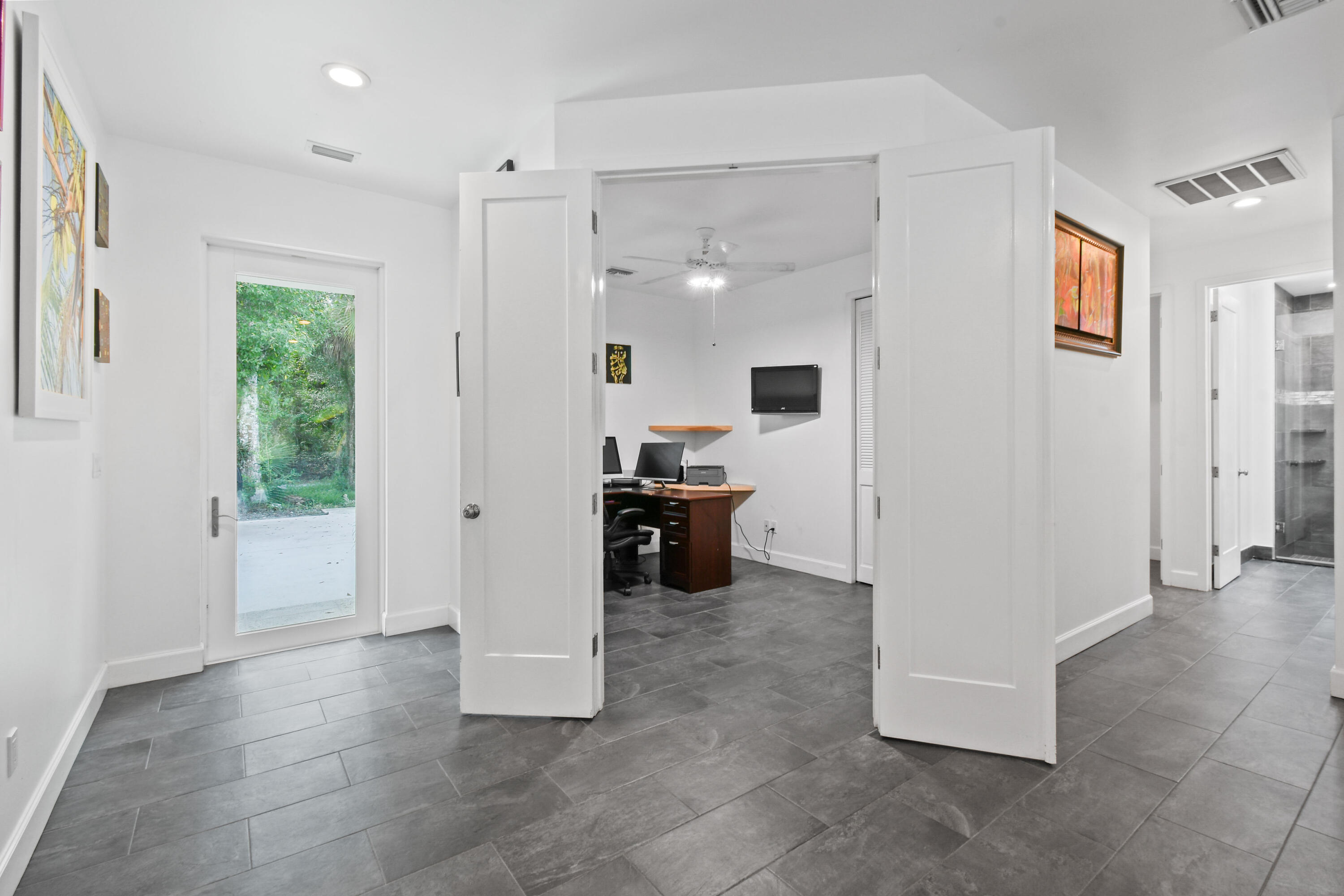 5782 Russakis Road Fort Pierce, FL 34951 - Photo 8 of 90 a view of a kitchen with a sink and dishwasher a refrigerator with wooden floor