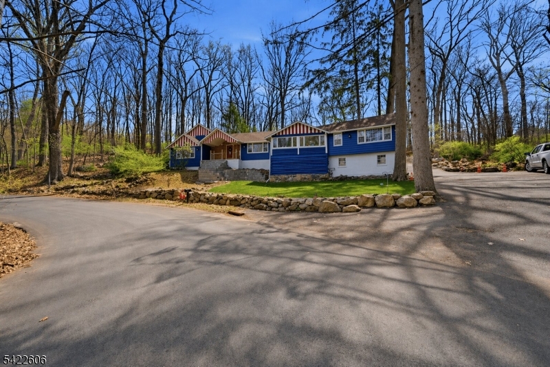 399 Springbrook Trail Sparta, NJ 07871 - Photo 2 of 27 a front view of a house with a yard and large trees