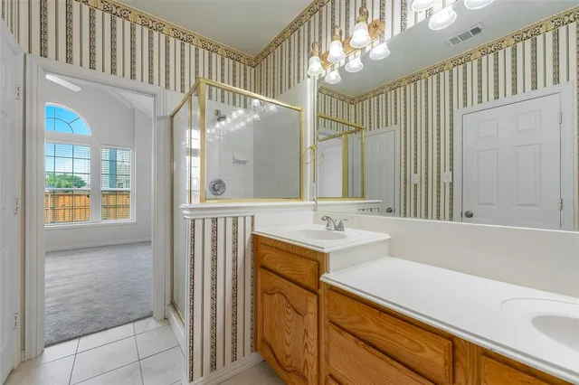 a bathroom with a sink a mirror and a shower