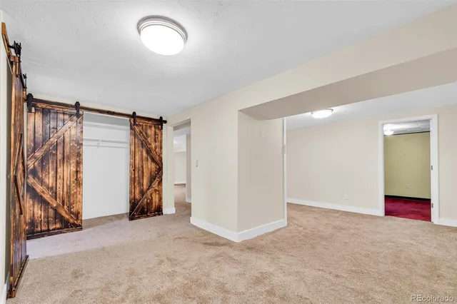 a view of walk in closet with empty racks