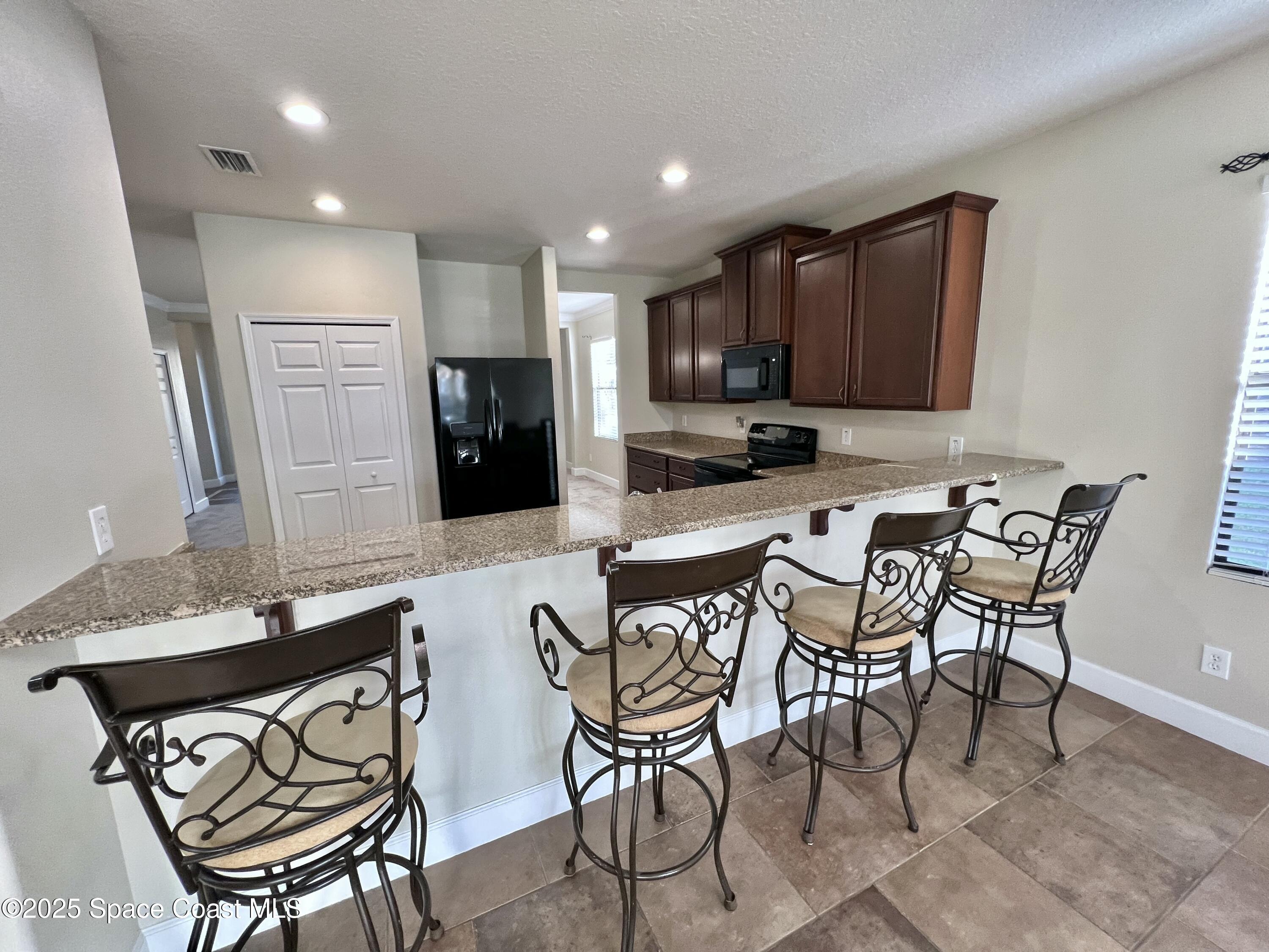 909 Whetstone Place Rockledge, FL 32955 - Photo 13 of 23 Breakfast Bar!