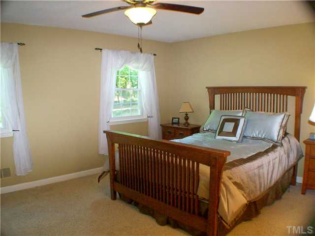 8805 Red Oak Court Raleigh, NC 27613 - Photo 6 of 12 Master retreat is spacious and relaxing. Walk in Cedar Closet is filled w customization from the built in dressers to the cabinets, shoe racks and adjustable hanging spaces. WOW. Gotta see it! Master bath has big dual vanity, tile floor and tile shower.