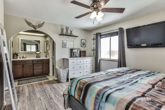 340 North Kern Street Ridgecrest, CA 93555 - Photo 28 of 33 a bedroom with a bed and a flat screen tv