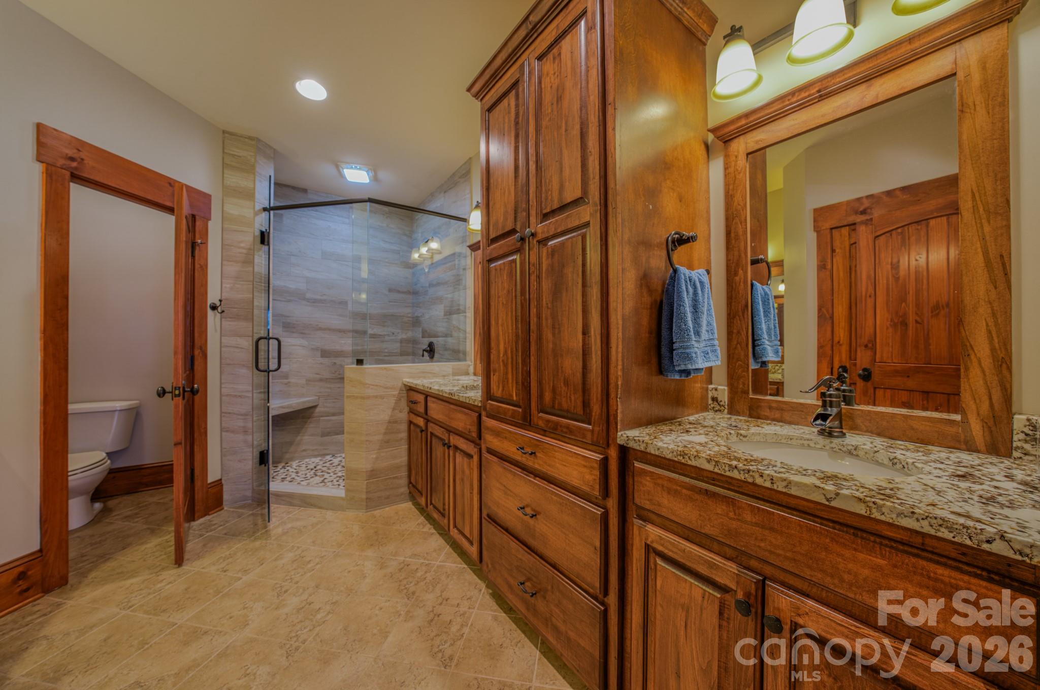 4836 Stream Side Lane, Unit 18 Morganton, NC 28655 - Photo 14 of 46 a bathroom with a granite countertop sink and a mirror