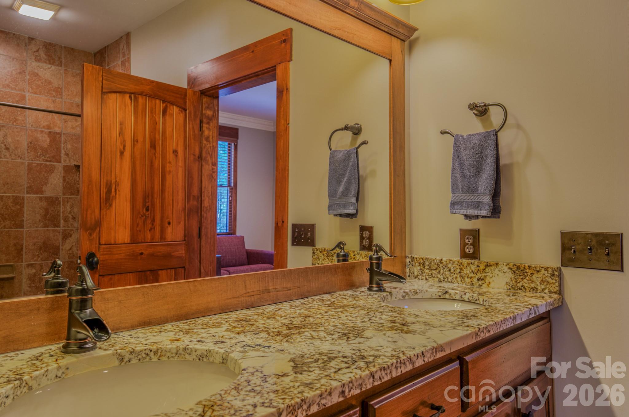 4836 Stream Side Lane, Unit 18 Morganton, NC 28655 - Photo 19 of 46 a bathroom with a granite countertop sink and a mirror
