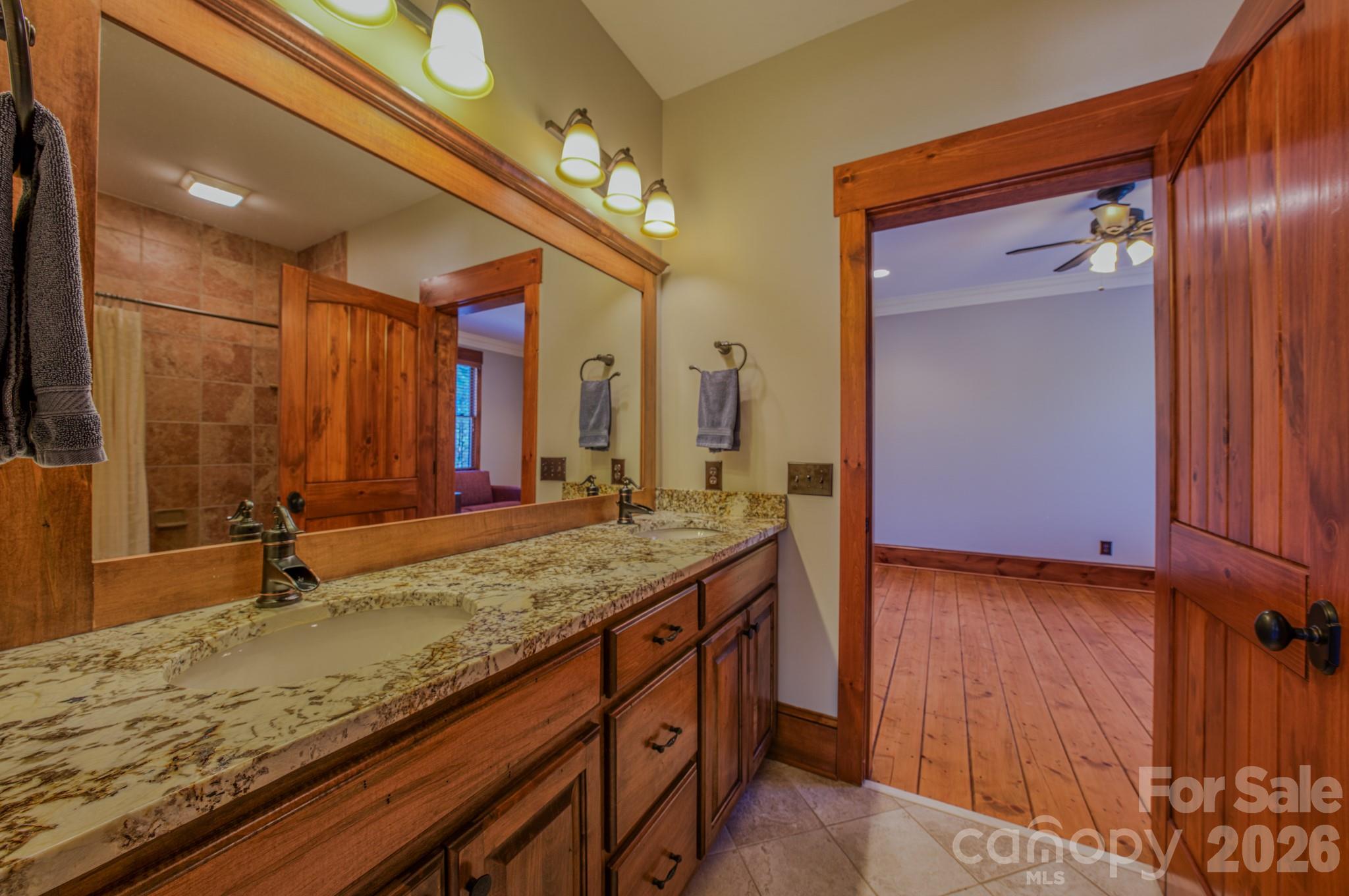 4836 Stream Side Lane, Unit 18 Morganton, NC 28655 - Photo 20 of 46 a bathroom with a granite countertop sink and a mirror