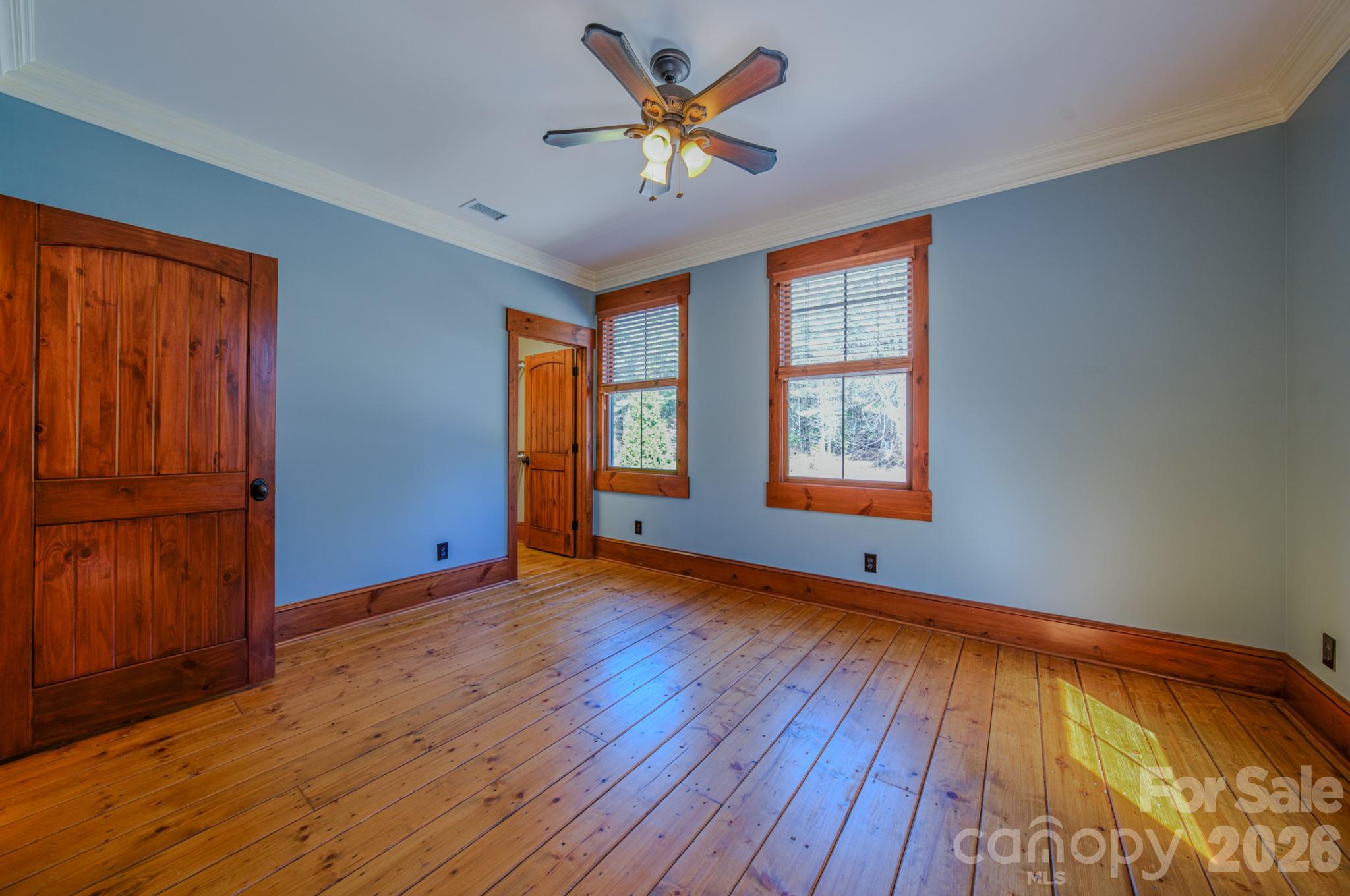 4836 Stream Side Lane, Unit 18 Morganton, NC 28655 - Photo 22 of 46 a view of an empty room with a window and wooden floor