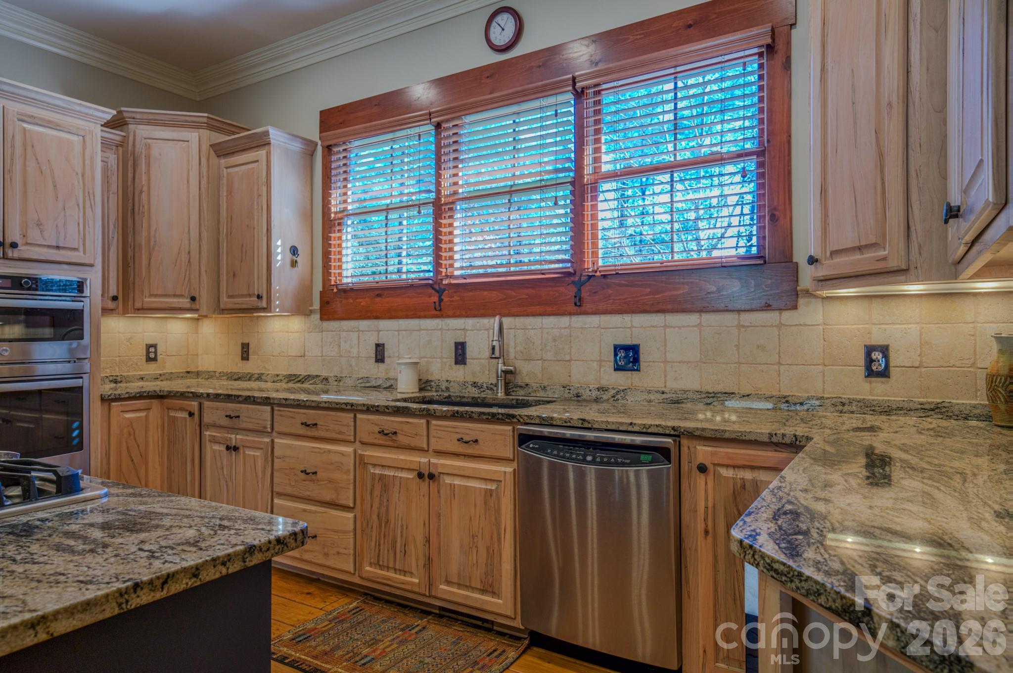 4836 Stream Side Lane, Unit 18 Morganton, NC 28655 - Photo 37 of 46 a kitchen with granite countertop a sink stove and cabinets