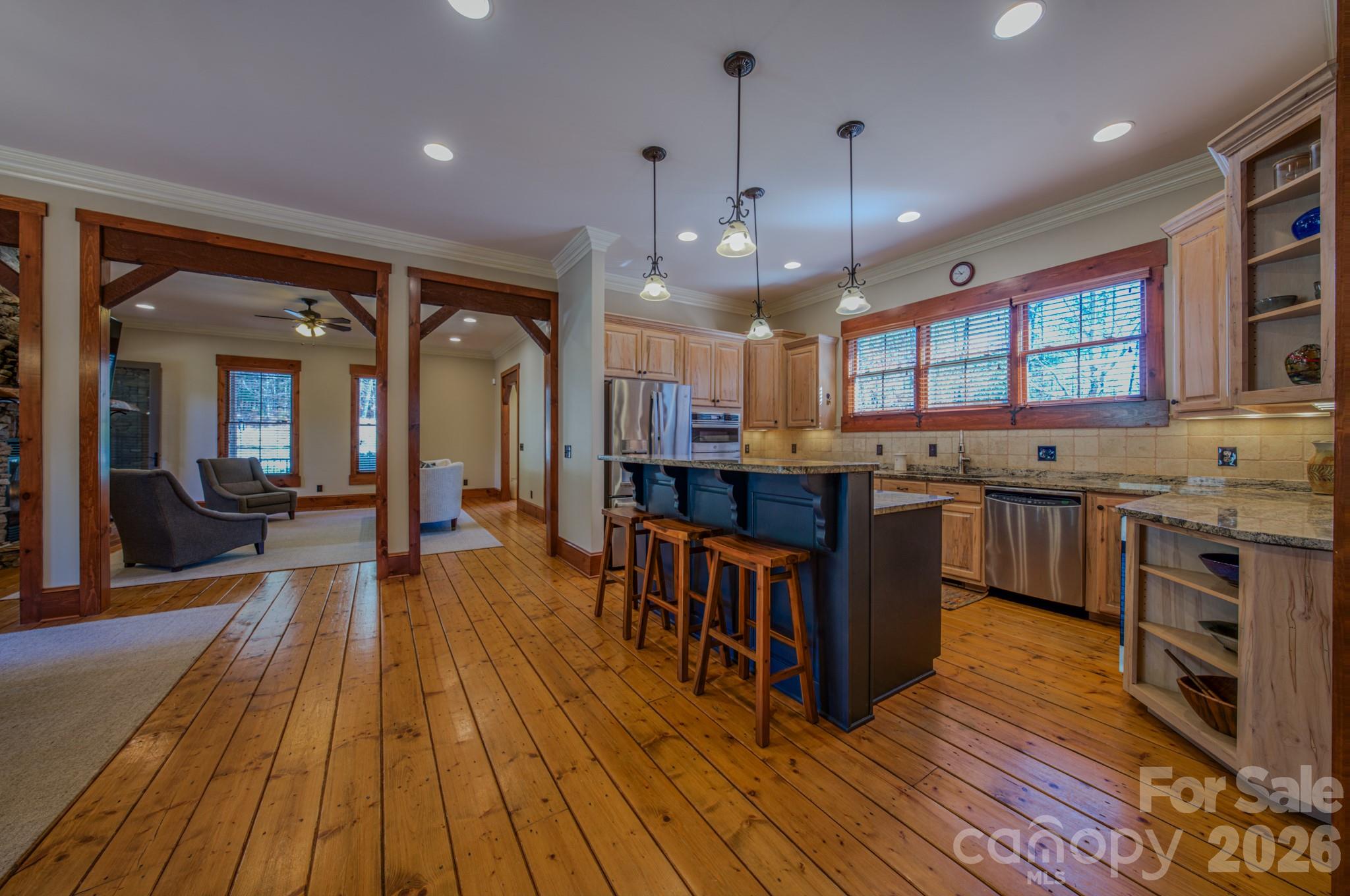 4836 Stream Side Lane, Unit 18 Morganton, NC 28655 - Photo 44 of 46 a large kitchen with stainless steel appliances granite countertop a lot of cabinets and wooden floor