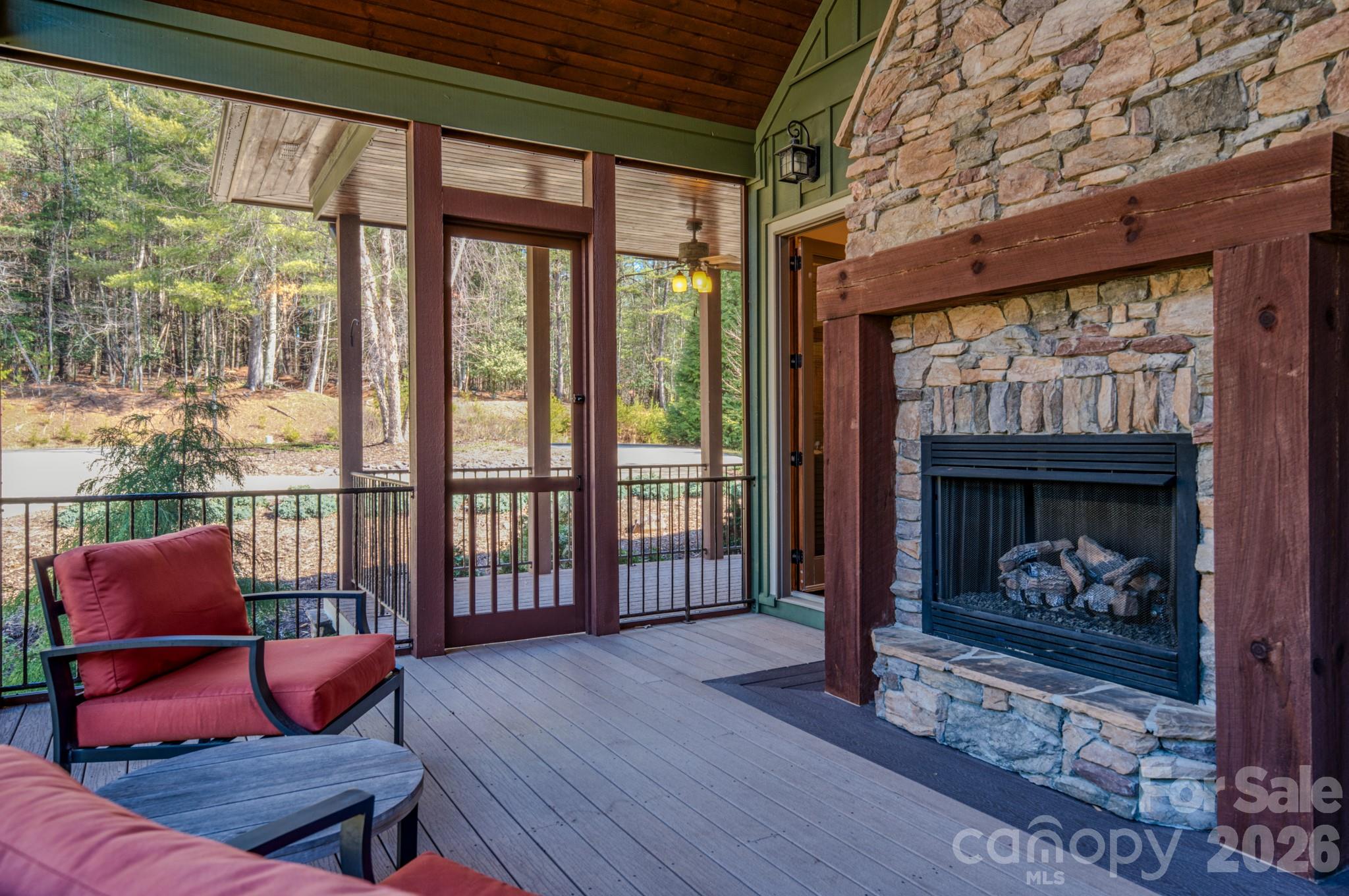4836 Stream Side Lane, Unit 18 Morganton, NC 28655 - Photo 7 of 46 a living room with furniture a fireplace and a floor to ceiling window