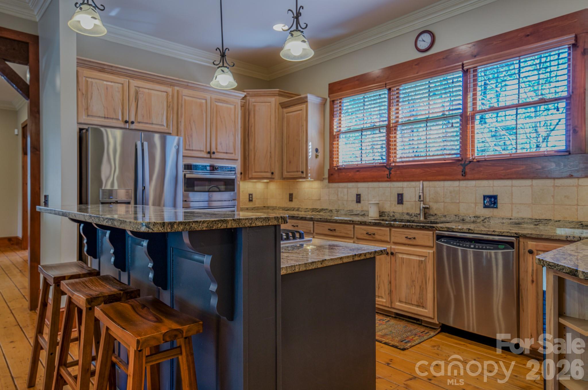 4836 Stream Side Lane, Unit 18 Morganton, NC 28655 - Photo 8 of 46 a kitchen with granite countertop a stove a sink and a refrigerator