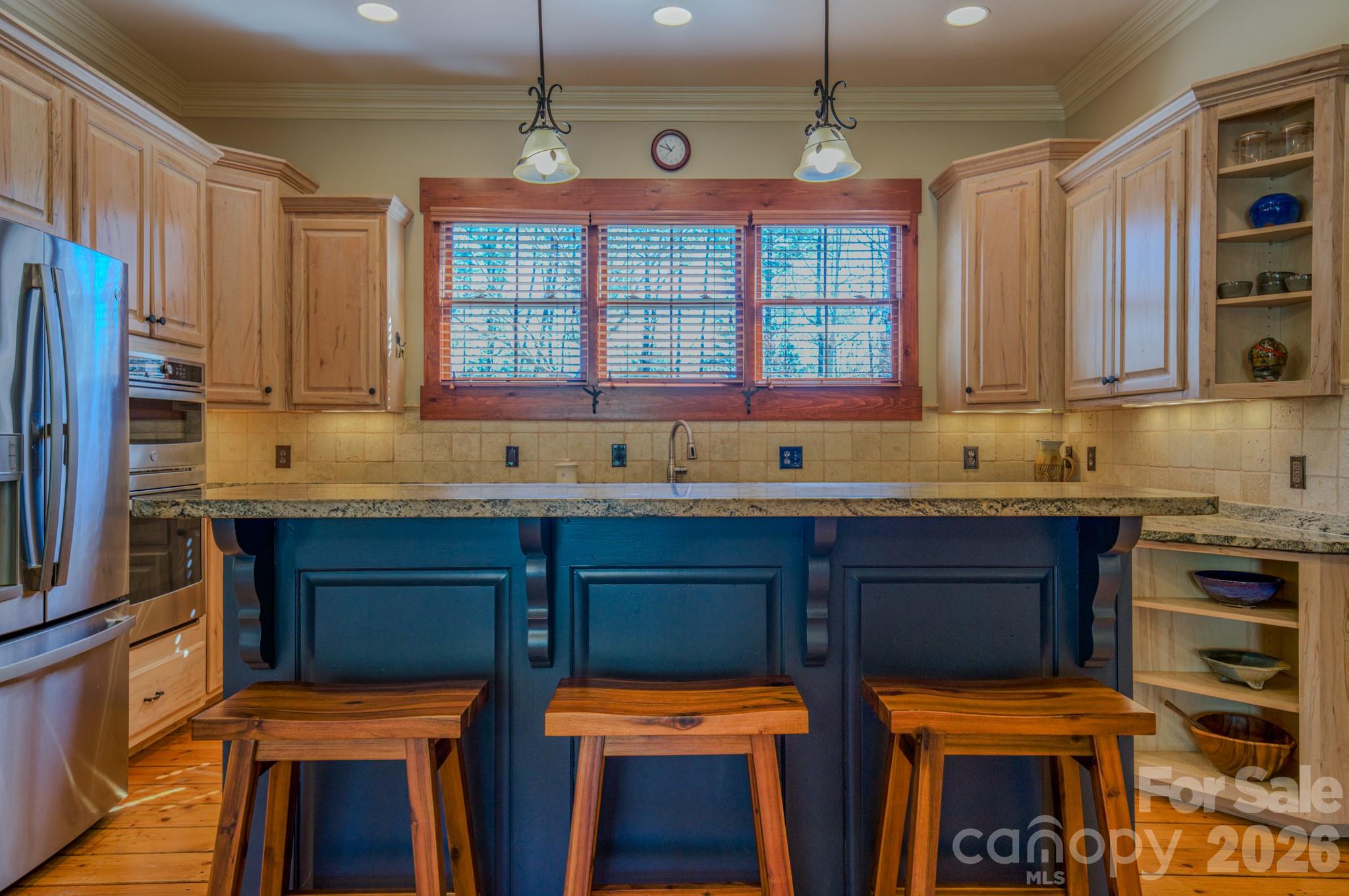 4836 Stream Side Lane, Unit 18 Morganton, NC 28655 - Photo 9 of 46 a kitchen with stainless steel appliances a stove a sink and a microwave