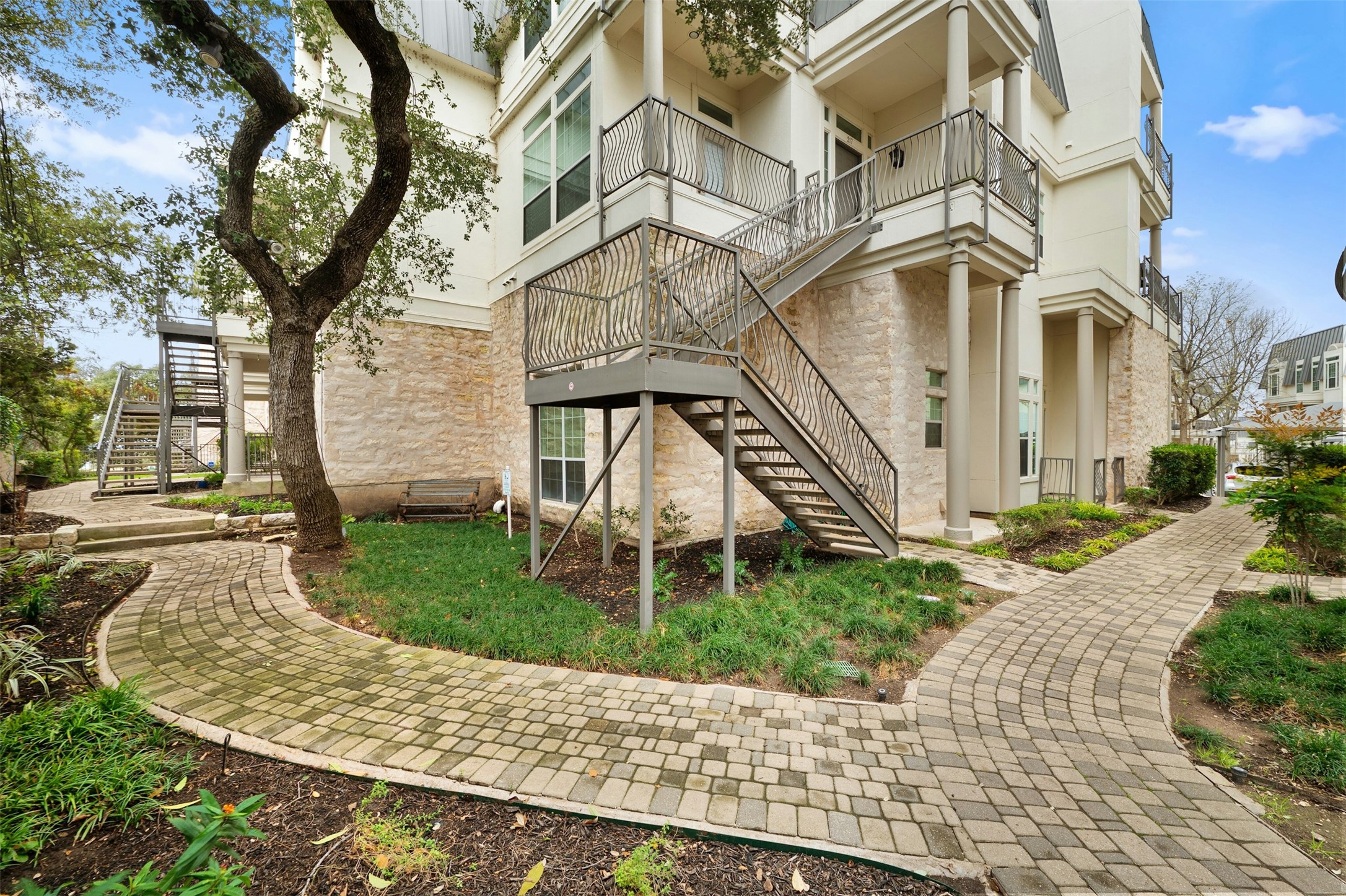 2918 Ranch To Market Road 620, Unit W219 Austin, TX 78734 - Photo 3 of 35 Charming stone paths and mature trees create a serene, walkable environment right outside your doorstep.