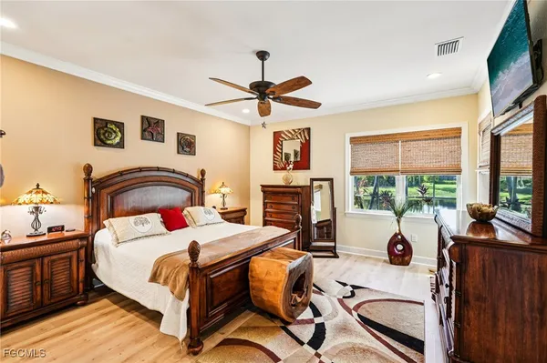 a bedroom with a bed and a chandelier