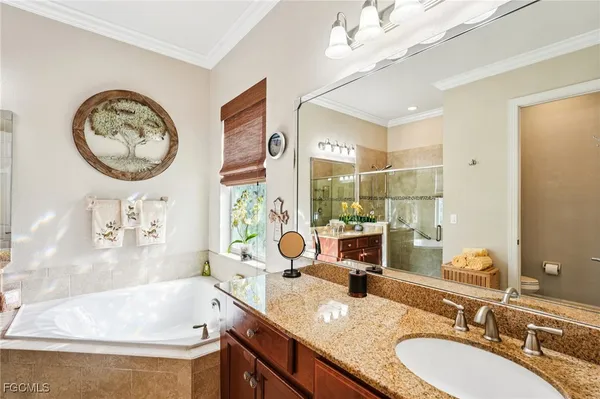 a spacious bathroom with a tub sink and mirror