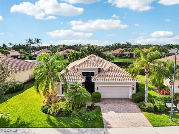 an aerial view of a house with garden space and ocean view