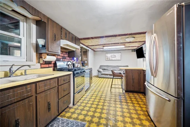 a kitchen with a sink appliances and cabinets