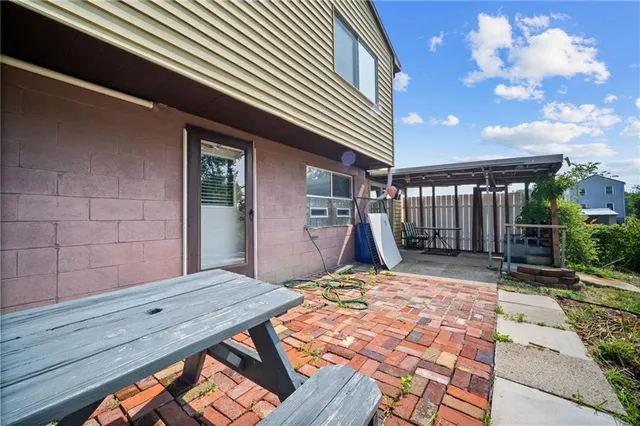 a backyard of a house with plants and tree