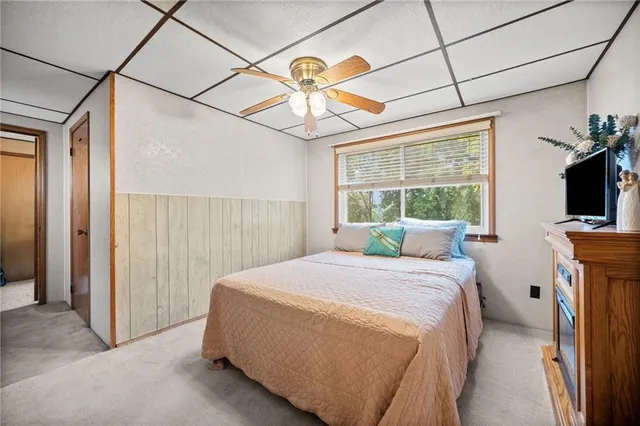 a bedroom with a bed and a television