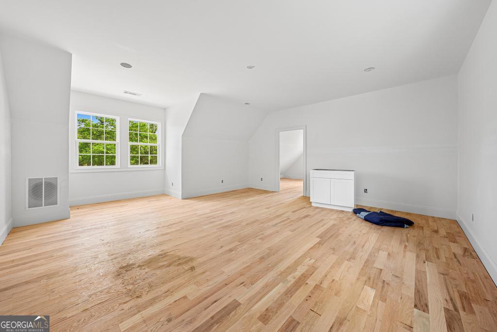 707 Vickery Street Extension Hartwell, GA 30643 - Photo 19 of 36 a view of an empty room with a window and wooden floor