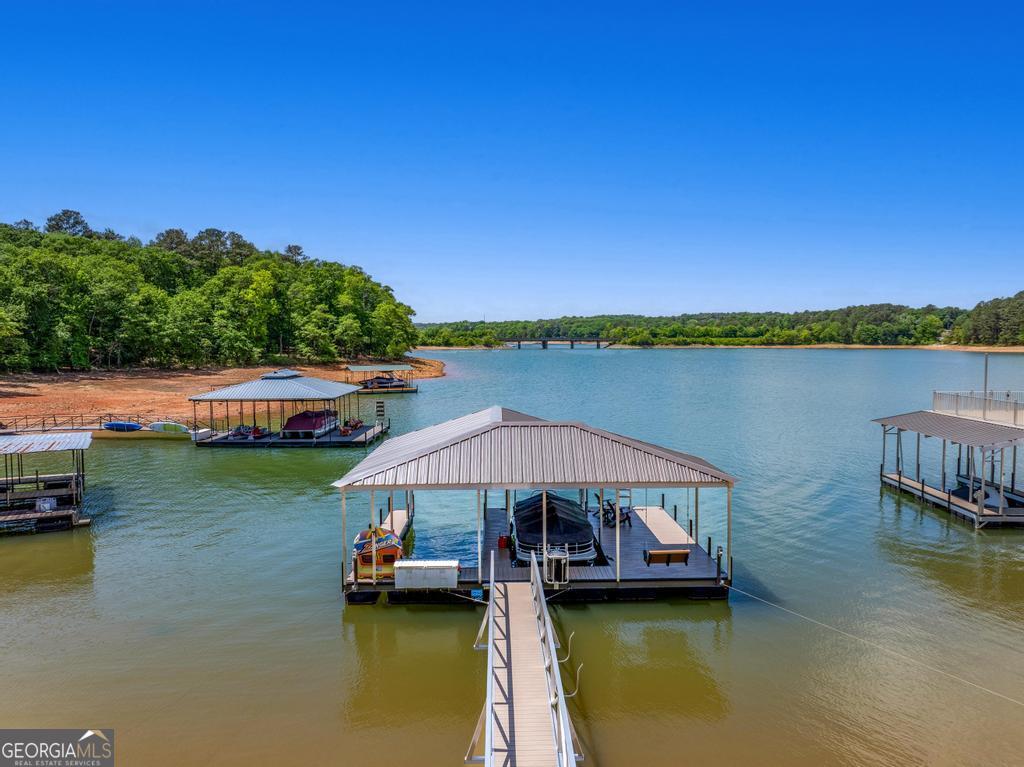 707 Vickery Street Extension Hartwell, GA 30643 - Photo 27 of 36 a view of a lake with a patio and a yard