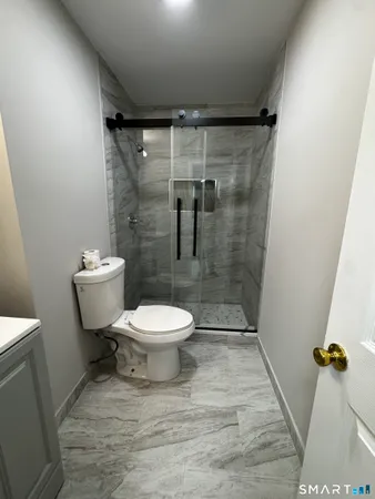 a bathroom with a toilet and a shower