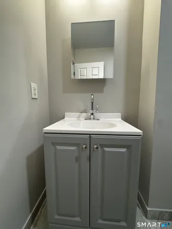 a utility room with a sink a mirror and vanity