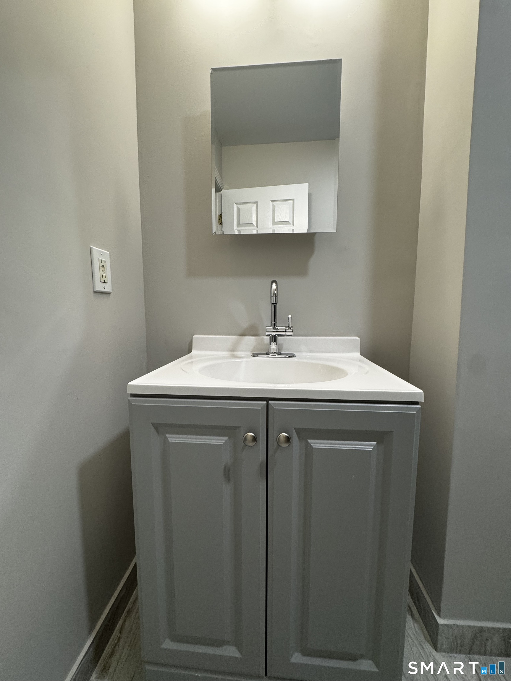 45-51 Cowles Street, Unit 45 Bridgeport, CT 06607 - Photo 14 of 33 a utility room with a sink a mirror and vanity