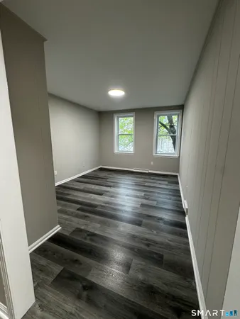 wooden floor in an empty room with windows