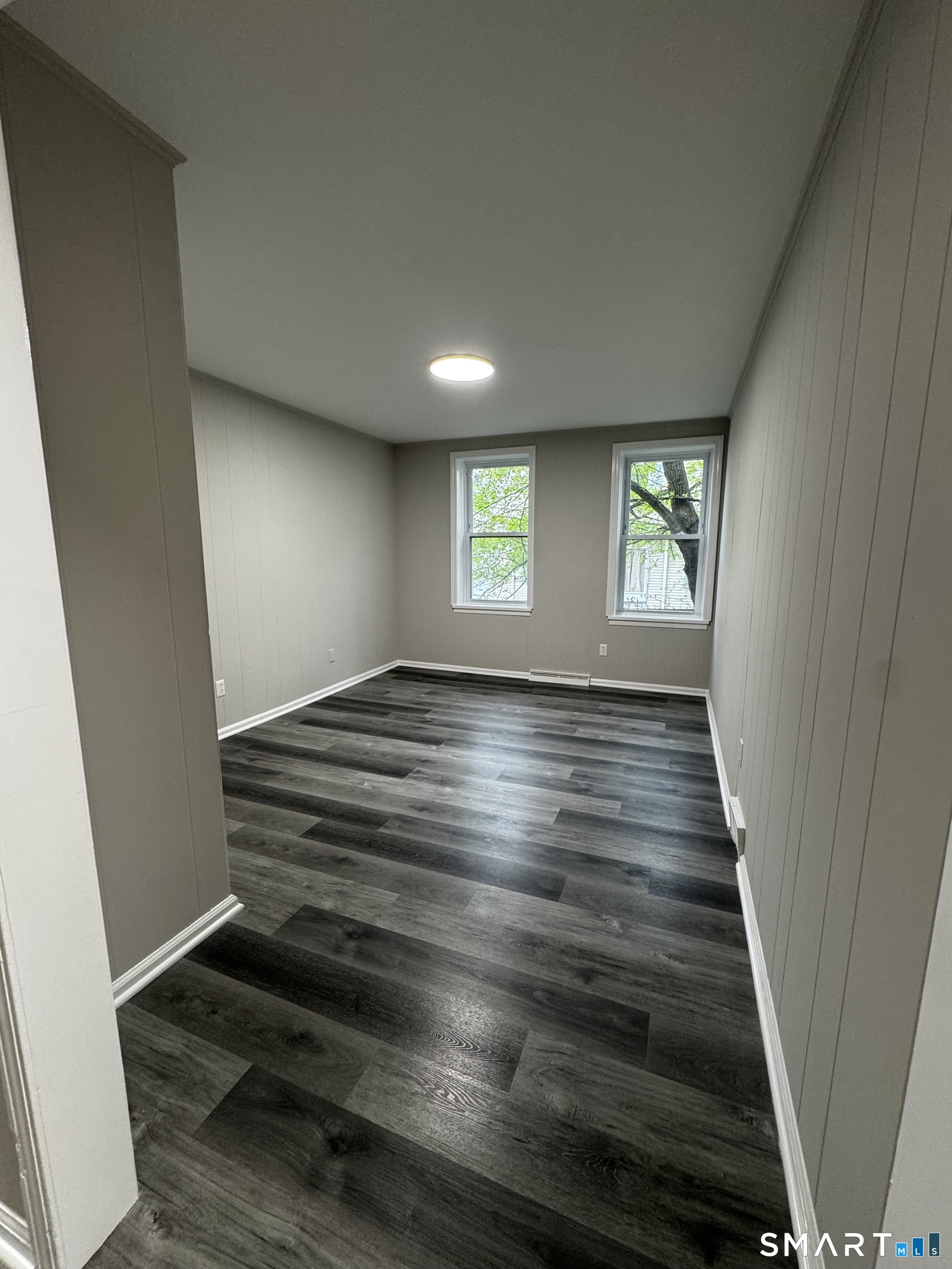 45-51 Cowles Street, Unit 45 Bridgeport, CT 06607 - Photo 15 of 33 wooden floor in an empty room with windows